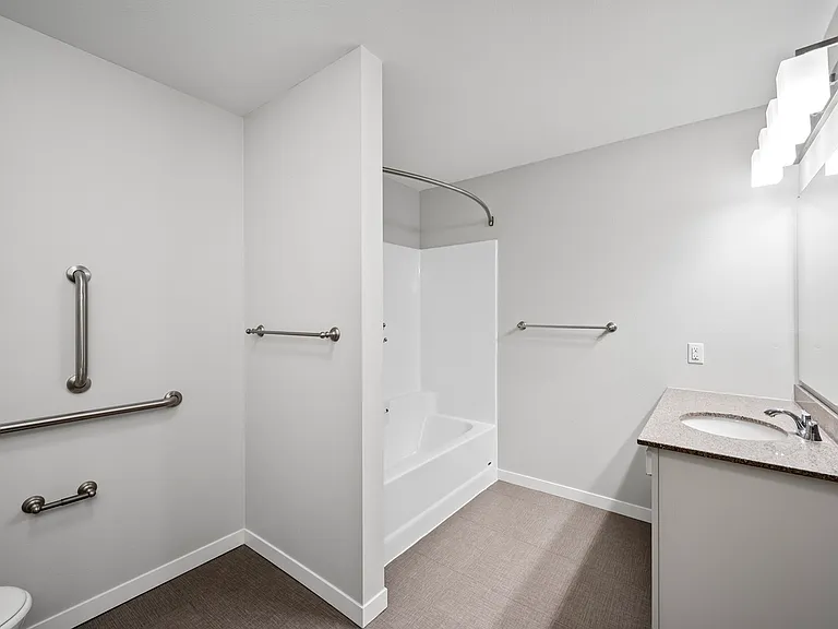 Bright and modern bathroom with sleek fixtures, spacious shower, and elegant countertop in a minimalist design. Bright and modern bathroom with sleek fixtures, spacious shower, and elegant countertop in a minimalist design.
