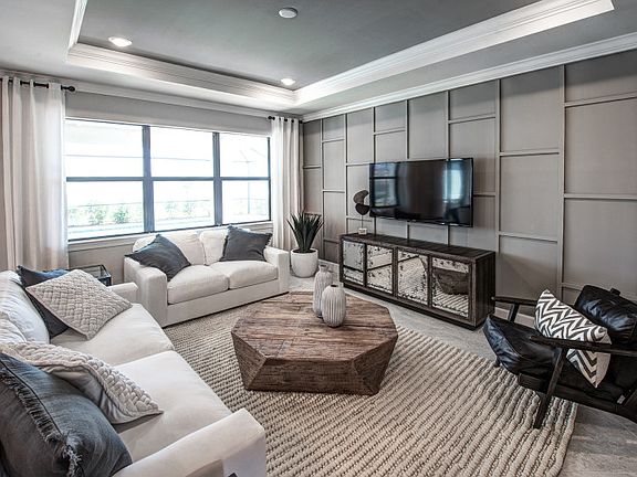 Model Representation Gathering room on first floor of home with ample natural light tray ceiling n