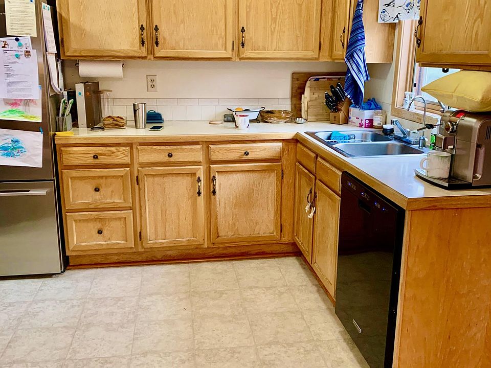 Small but efficient kitchen with new stove, dishwasher, and fridge,