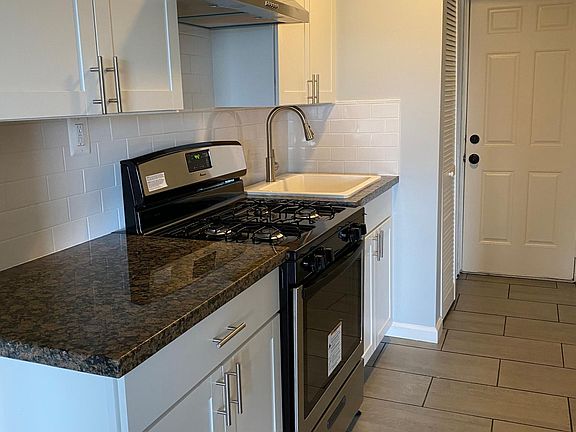Newly updated kitchen with brand new cabinets, new tile floors and stainless steel appliances, including a gas cooking range. Closet space off of kitchen that can be used as pantry storage.