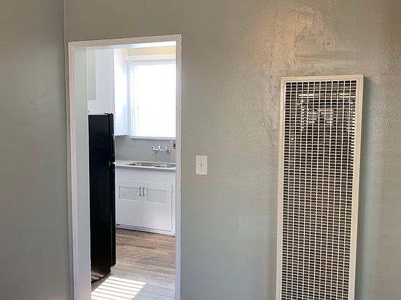 View of kitchen from dining room with heater.
