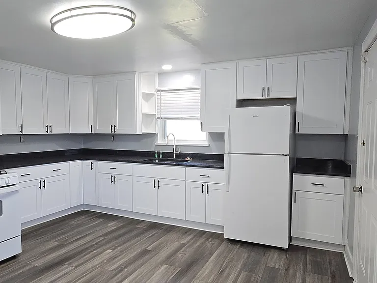 Fully remodeled kitchen with new flooring, cabinets, and appliances.