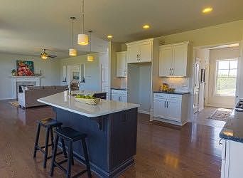 Bright and beautiful kitchen. View the open floor plan looking into the family room. Gleaming hardwo