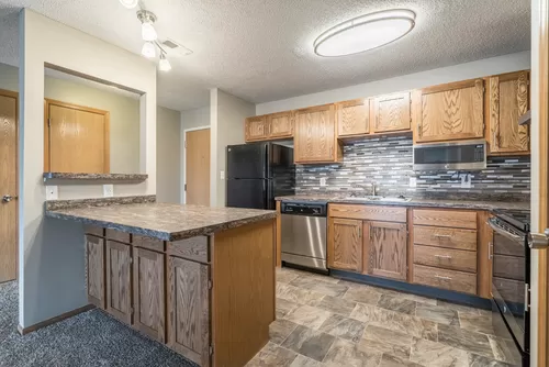 Our renovated apartments feature updated cabinetry, countertops, appliances and tile backsplash. - Highland View Apartments