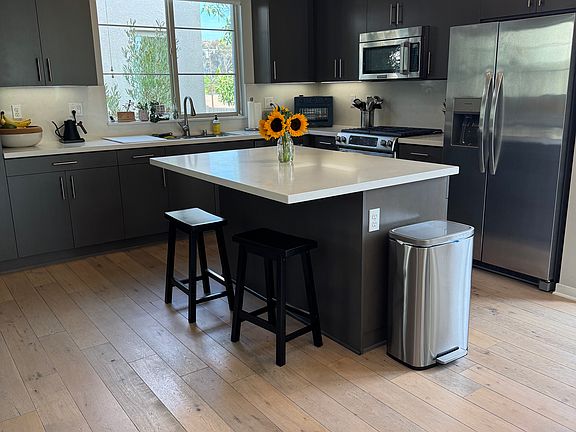 Open concept kitchen, dining, living spaces