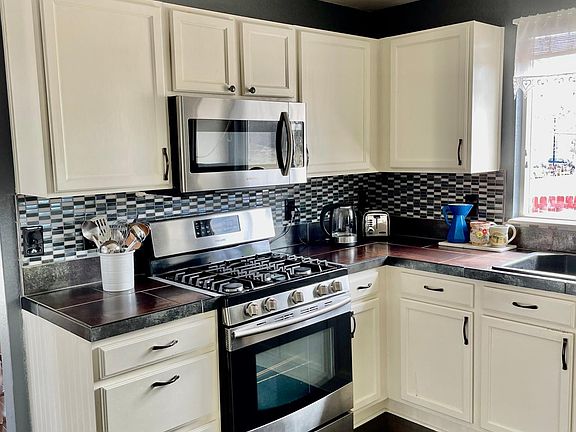 Kitchen with newer stainless steel appliances and gas stove