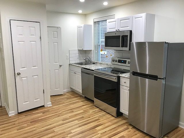 Kitchen area with Closet shown near apartment entry door