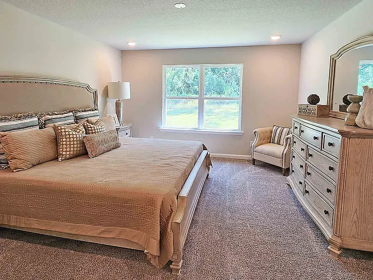 Primary bedroom with window overlooking the backyard.
Includes large walk-in closet.