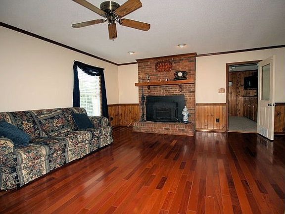 Gleaming wood floors and fireplace in the living room.