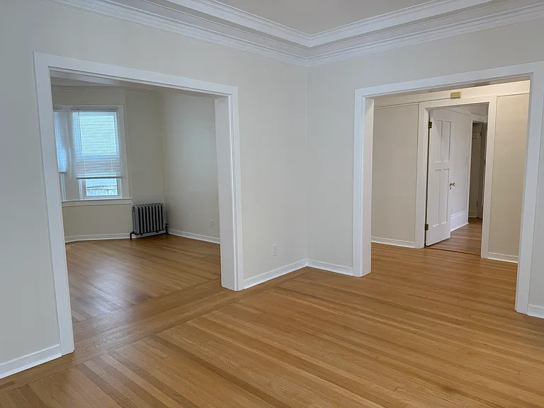 standing in dining room corner with LR on the left and hallway straight ahead