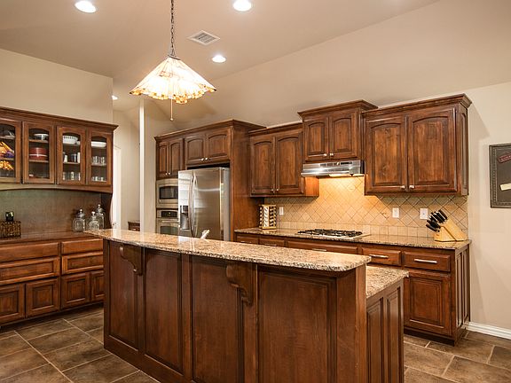 Culinary open Kitchen features granite countertops, beautiful cabinetry with brushed nickel hardware, stainless steel appliances and built-in china hutch. 
