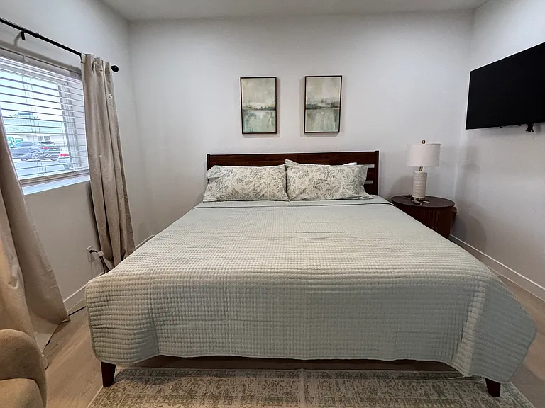 King bed with a wall-mounted TV _ comfortable enough to spend a quiet evening in without leaving the room.