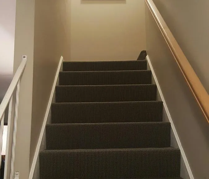 Carpeted Stairwell at Entry to Second Floor
