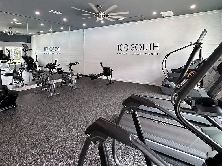 Experience a sleek and spacious workout environment at 100 South Luxury Apartments, complete with ellipticals, treadmills, rowing machines, and spin bikes.