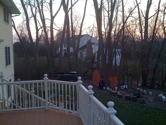 Looking west off of deck Mid trees to property line