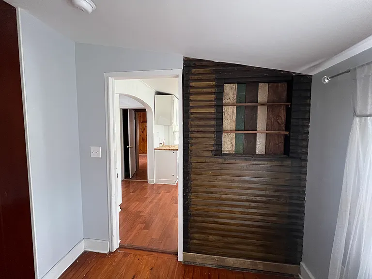Bedroom 1 with exposed shiplap and custom decorative shelves. 2 closets!!
