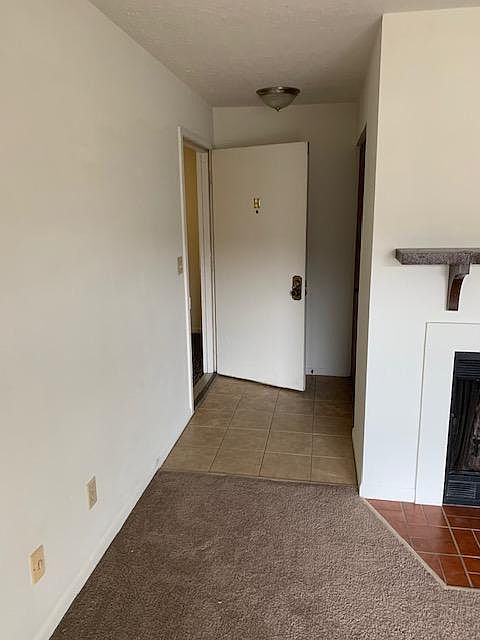 Entry of unit standing in living room- coat closet on right across from front door