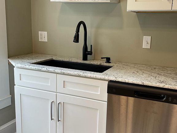 Granite countertop - decorative shelves - note dishwasher to the right