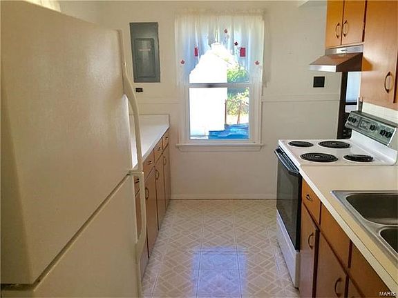 Kitchen area with refrigerator to stay.