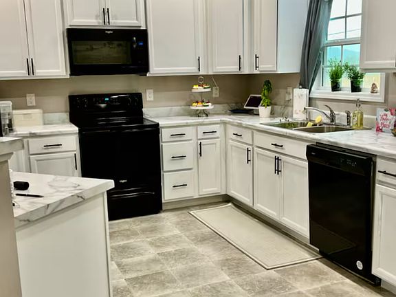 Kitchen includes fridge, oven, microwave