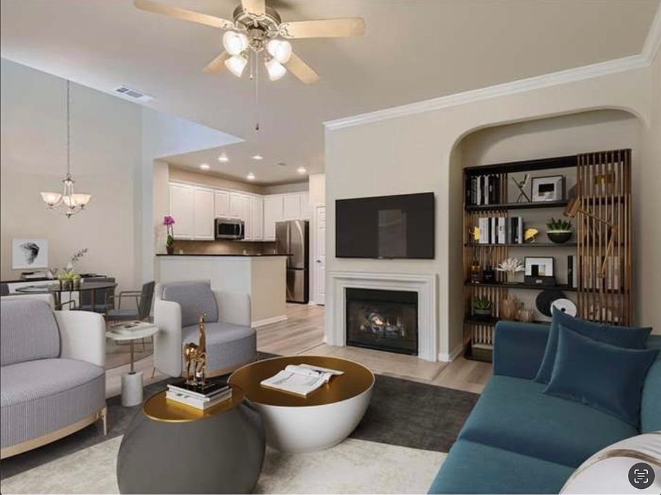 Living area with new vinyl flooring, new paint, crown molding, gas fire place.
