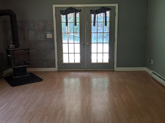 French doors provide plenty of light; wood stove warmth and mood