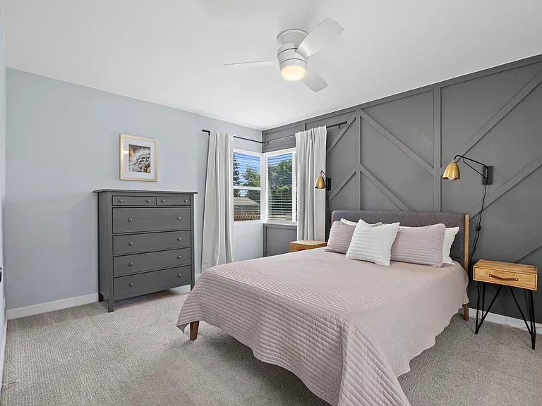 Primary bedroom with natural light & queen bed. Blackout curtains on all bedroom windows.