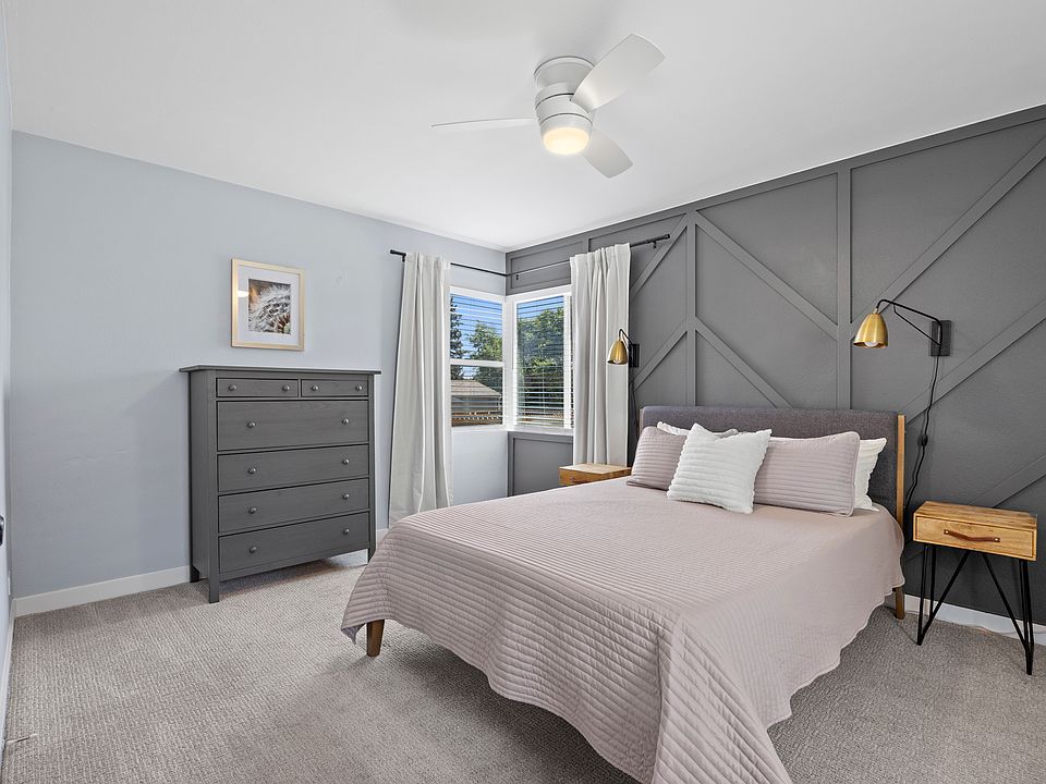 Primary bedroom with natural light & queen bed. Blackout curtains on all bedroom windows.