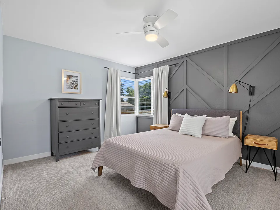 Primary bedroom with natural light & queen bed. Blackout curtains on all bedroom windows.