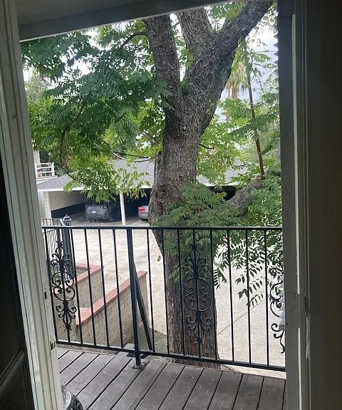 Small rear patio & view of carport