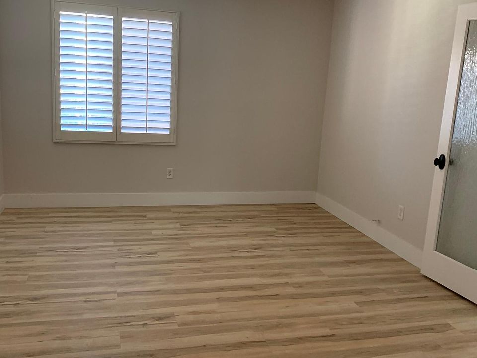 Large, bright bedroom with wall in closet.