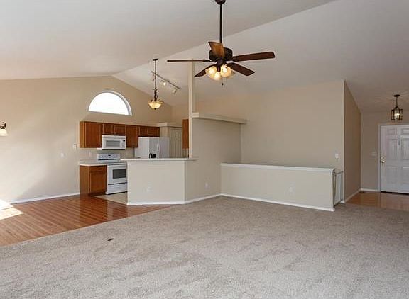 Vaulted open floor plan!  View of stairs to lower level and front door