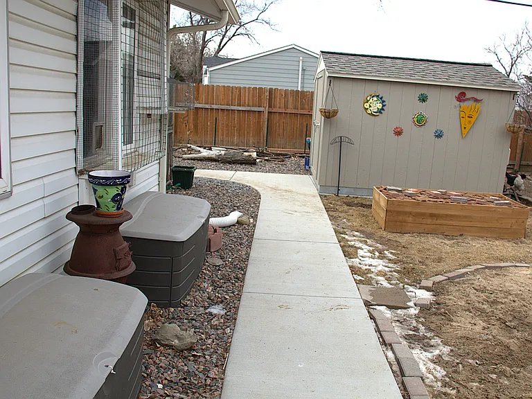 10'x8' shed and 6'x2' planter box, cement walkway to chicken coop (garden art not included)