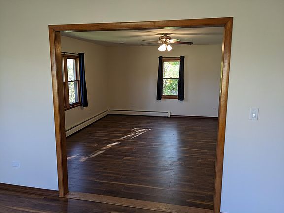 Large living room (17' x 19') with new flooring and ceiling fan.