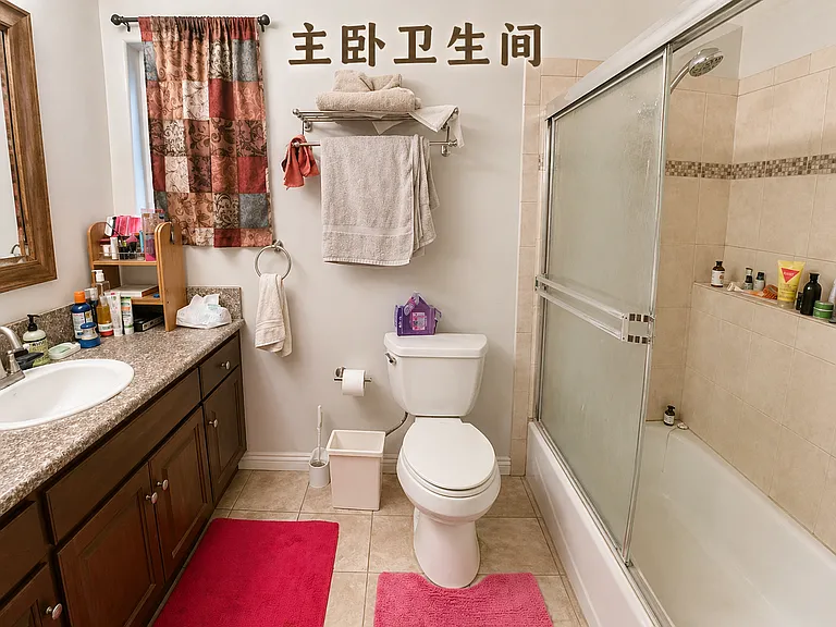 Full bathroom complete with a large vanity, integrated shower/tub combination, and clean ceramic tile flooring.