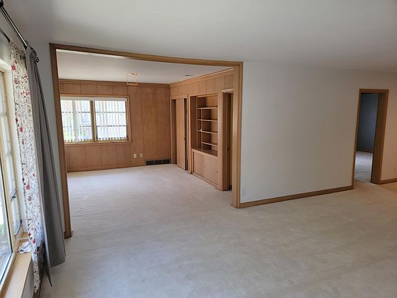 Large living room with corner den and cabinets.