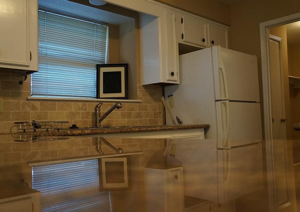 Granite and travertine Kitchen overlooking living room
