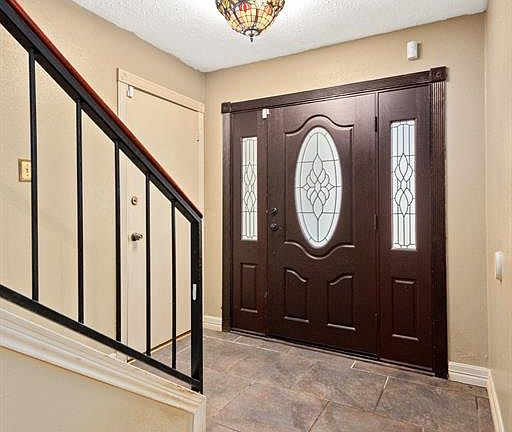Gorgeous front door leads into this tiled entry