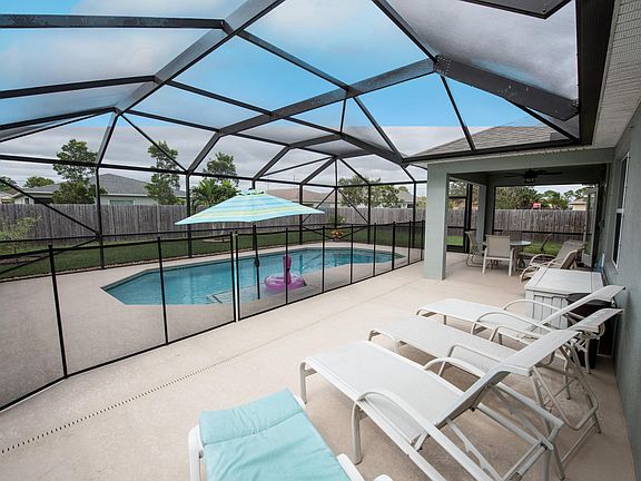4 Lounge chairs, outdoor dining table with 4 chairs and 2 rocking chairs with small table, and pool toys.