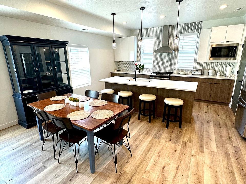 Second floor living area showing dining room table, plus island bench seating, and general kitchen area.