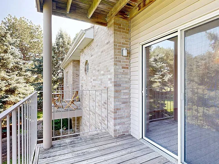 Covered balconies offer comfortable outdoor spaces to unwind while taking in peaceful views of surrounding greenery.