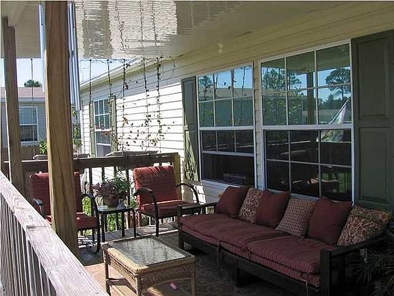 Charming front porch looks inviting to sit in the shade, it is large enough fo