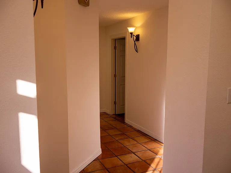 Hallway Left of Entrance that Leads to Rooms