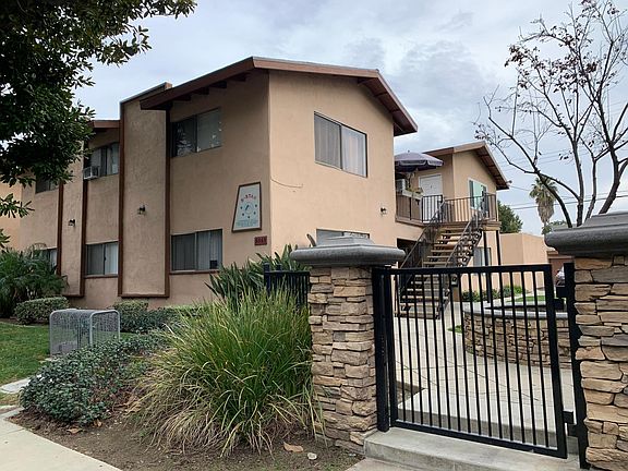Side view of building. Unit for rent is upstairs back unit.