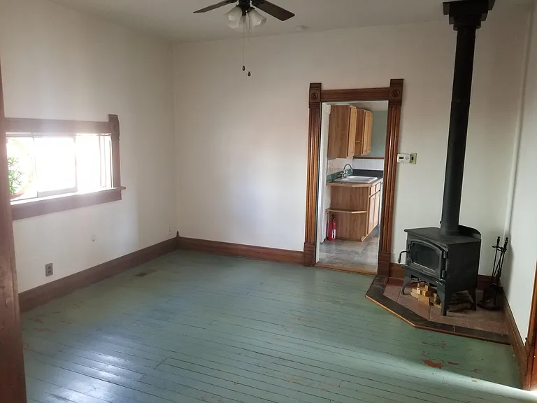 livingroom unfurnishied with wood burning stove