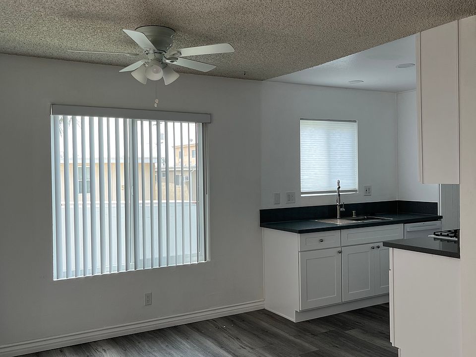 Dining off of living (East). Partial kitchen view.
