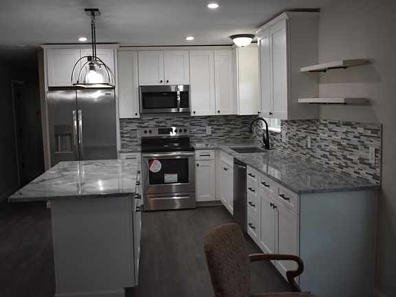 Fully updated Kitchen with island, granite countertops, New Cabinets and Backsplash. The home has New Stainless Steel Appliances and New Light Fixtures.