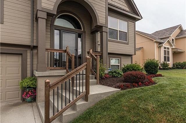 Beautiful landscaping welcomes you to 1903 Kimberly Lane, Greenwood, MO 64034!