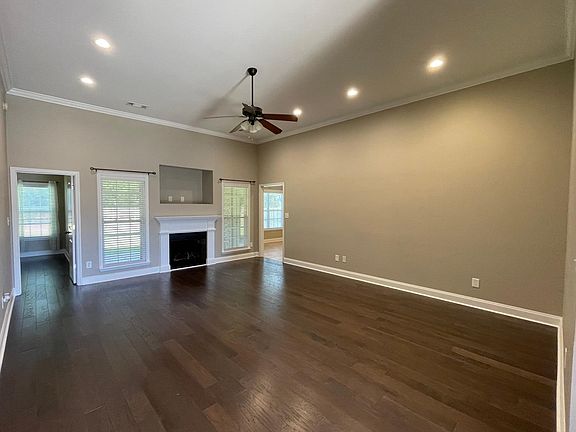 Large living room with high ceilings and fireplace.