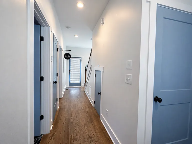 Just past the laundry room with fully stocked washer and dryer is the long highway that leads to the first bedroom and backyard.